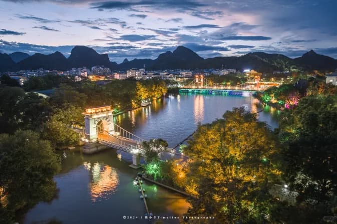 A lit bridge on the Two Rivers and Four Lakes waterway in Guilin at night