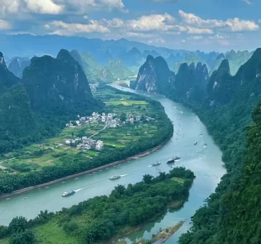The Li River curving past a riverside village between karst hills