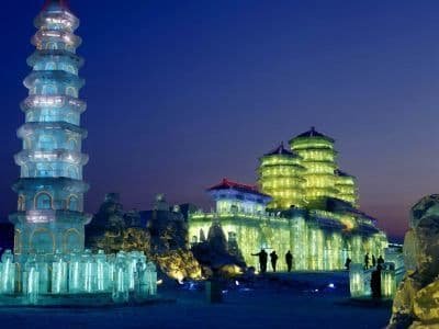 Ice pagodas lit from within after dark at Harbin Ice and Snow World