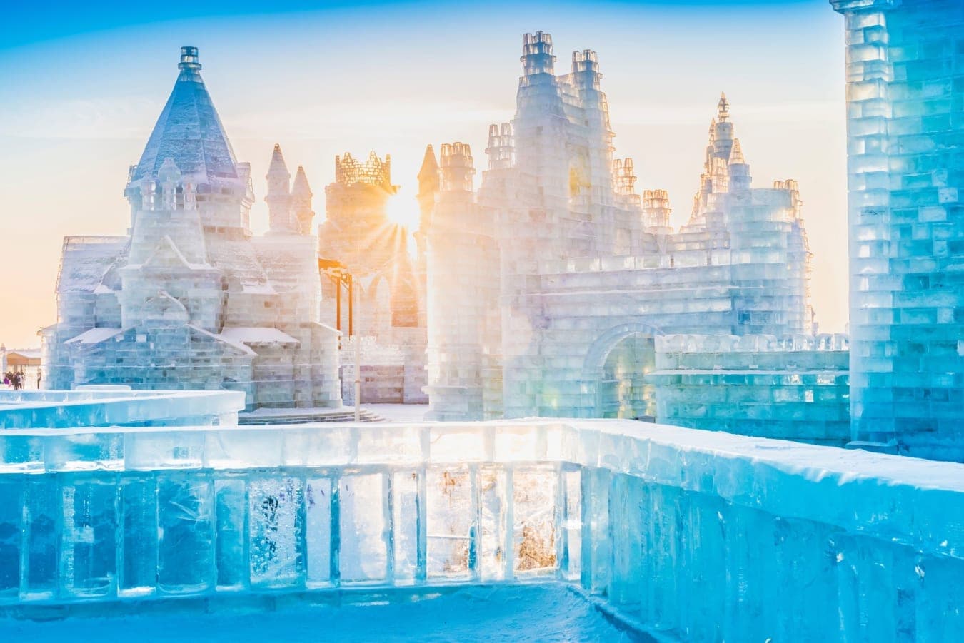 Ice castles at Harbin Ice and Snow World backlit at sunrise