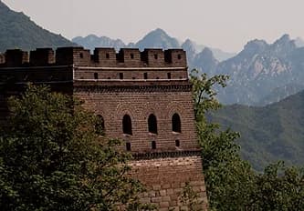 Restored watchtower against the mountain ridge