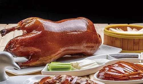 Roast Peking duck served with pancakes