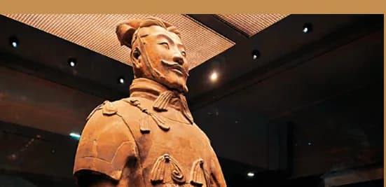 A terracotta officer figure displayed under museum lighting