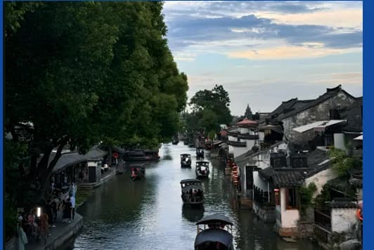 Boats on a canal lined with white-walled houses in Zhujiajiao