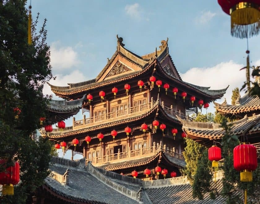 A lantern-hung timber temple pavilion in late-afternoon light