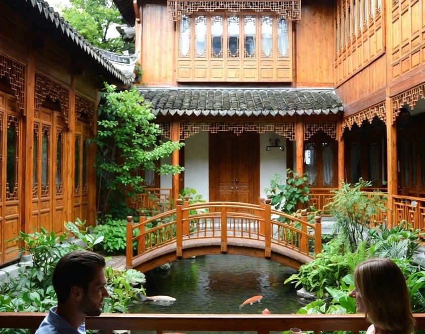 Two guests beside the koi pond of a timber courtyard hotel